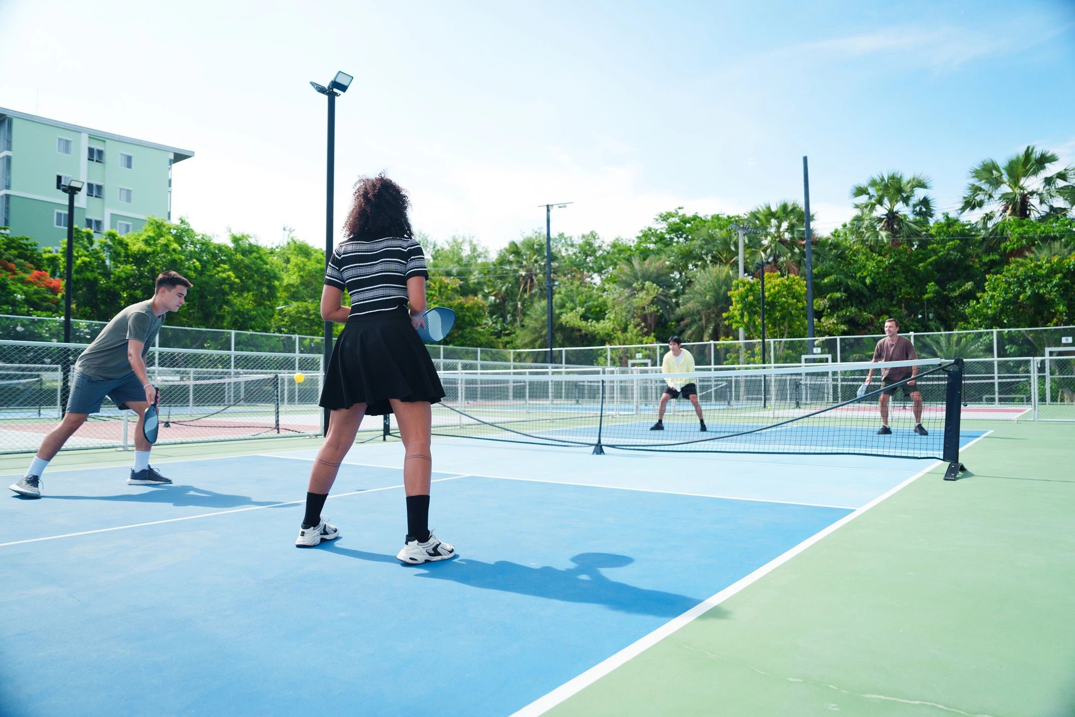 Players enjoying competitive pickleball on an outdoor court